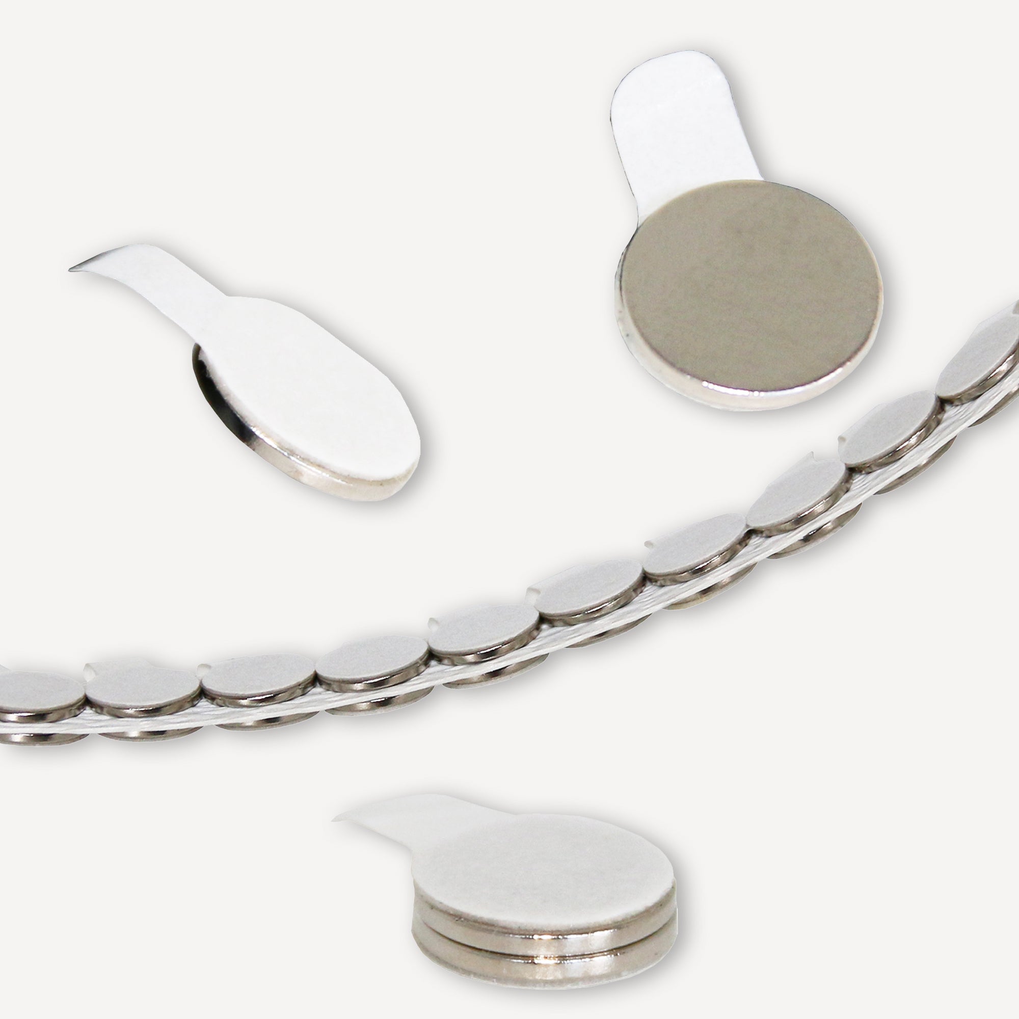 Selbstklebender Scheibenmagnet aus Neodym mit der Abmessung Ø10x1mm auf einem Trägerband